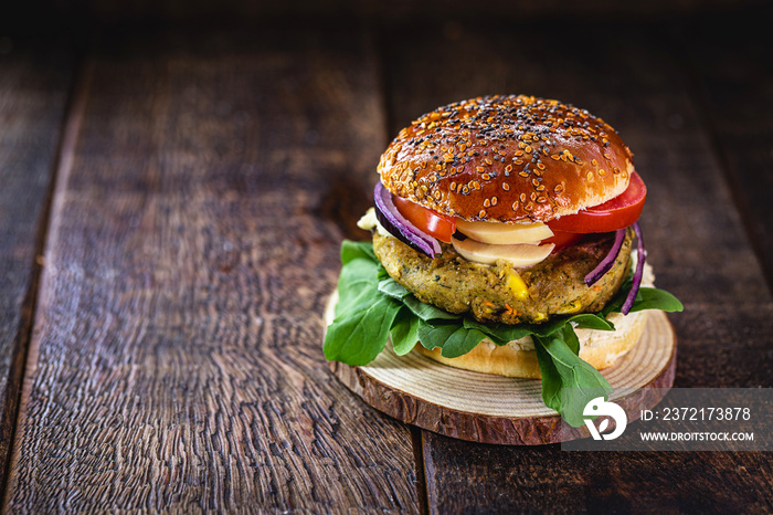 Vegan hamburger, Sandwich made without meat, with glass of green juice in the background. Sandwich w