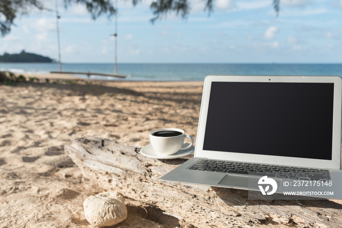 Laptop and a cup of coffee sea view