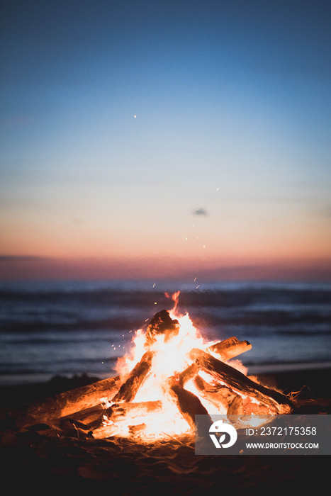 beach bonfire with sunset in background