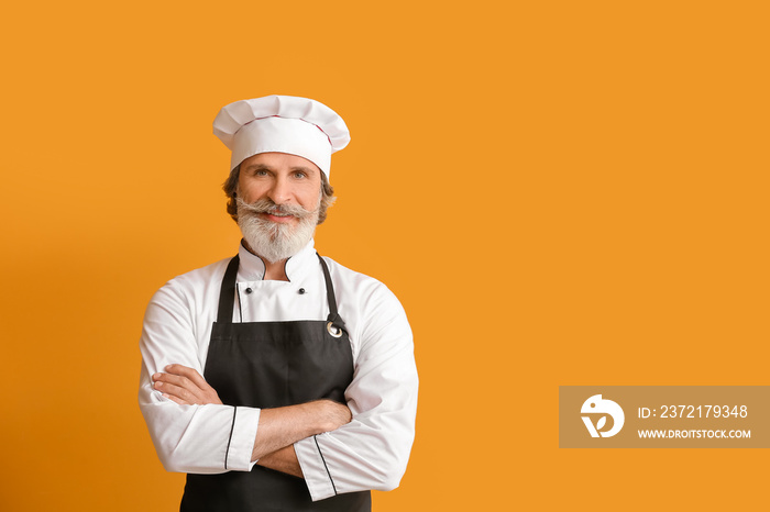 Mature male chef on color background