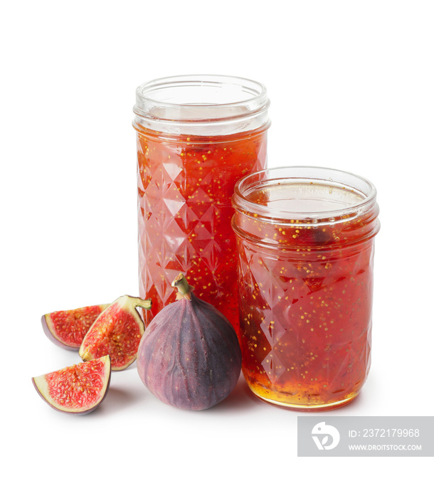 Jars of sweet fig jam on white background