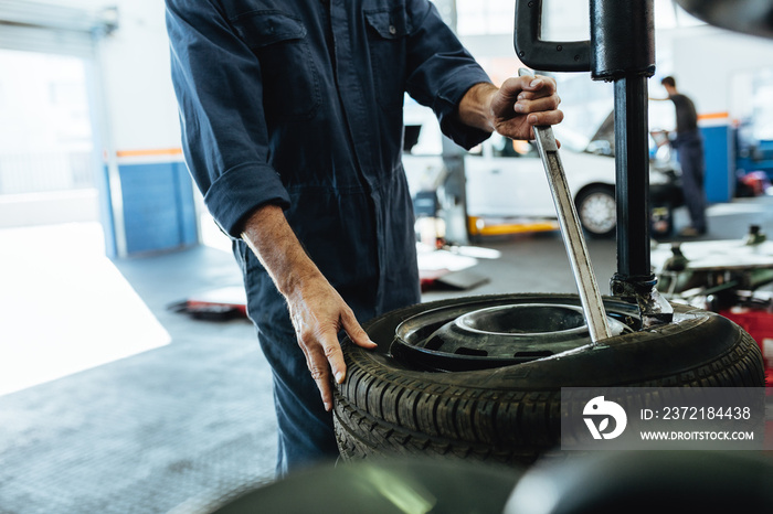 Mechanic working on tire changing machine