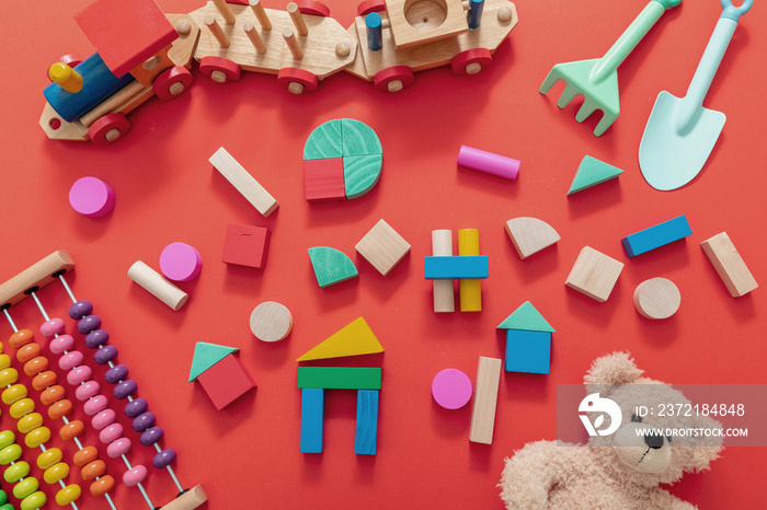 儿童玩具、泰迪熊、彩色木块和红色背景的火车