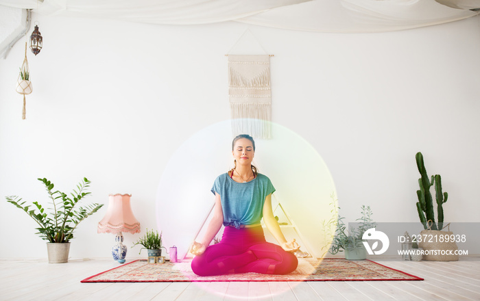 mindfulness, spirituality and healthy lifestyle concept - woman meditating in lotus pose at yoga stu