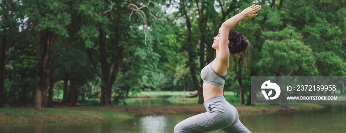 Fitness asian woman doing yoga in park