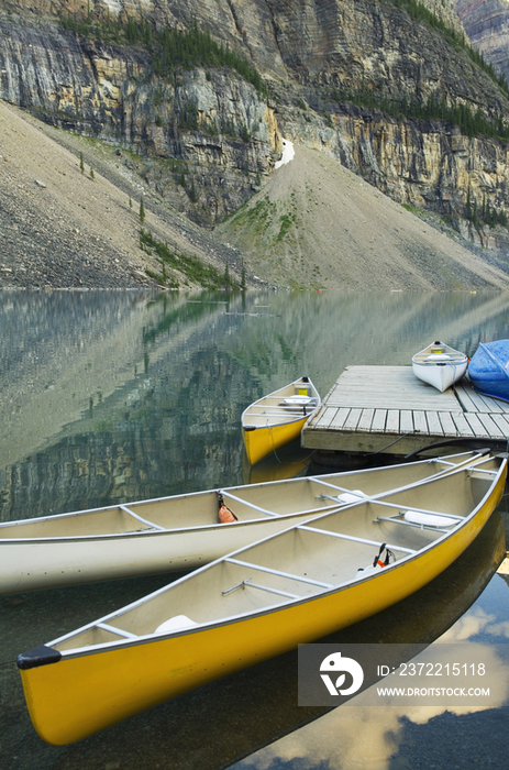 Colorful canoes on dock of Moraine Lake