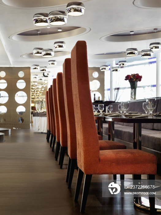 Interior of dining area with tall back chairs in luxury hotel