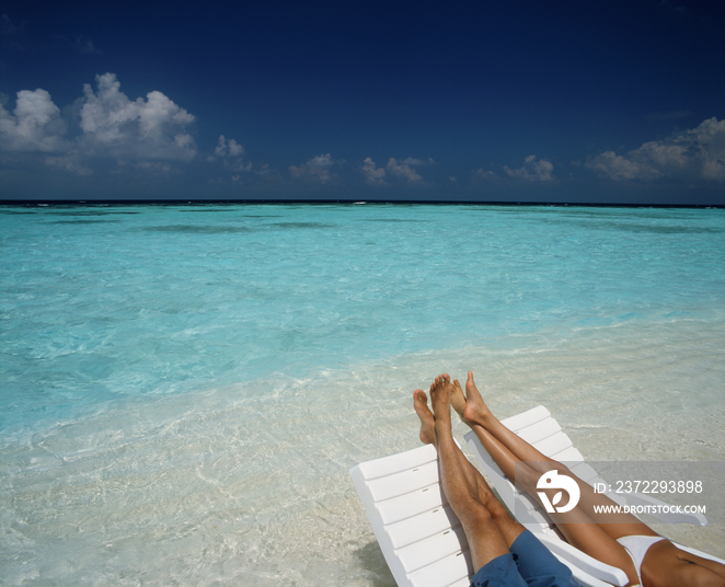 Maldives, Blue Lagoon, Couple relaxing on the beach