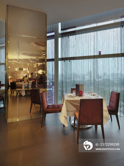 Table and chairs arranged in luxury hotel