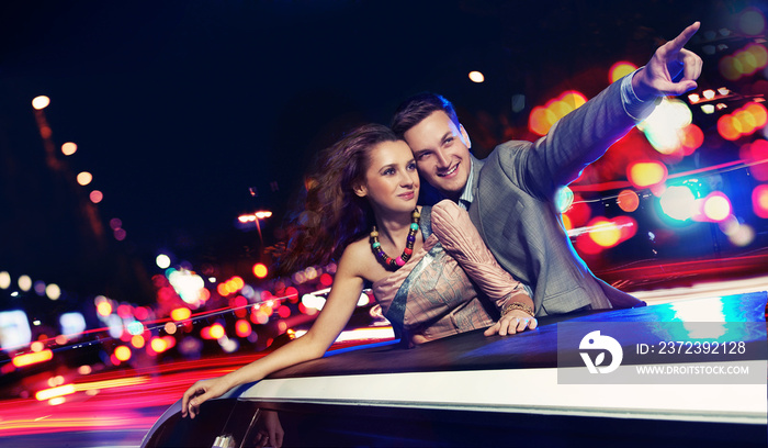 Elegant couple traveling a limousine at night