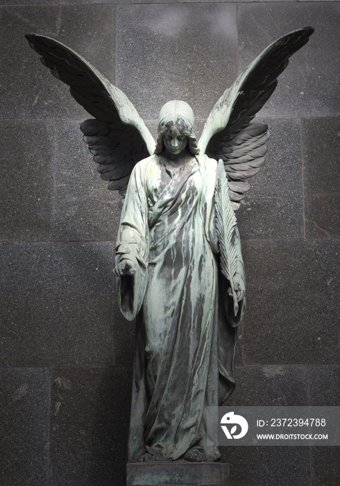 Monument of old angel on cemetery in Warsaw