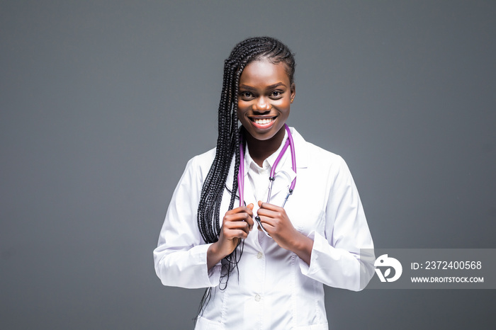 Pretty african american woman intern nurse isolated on gray background