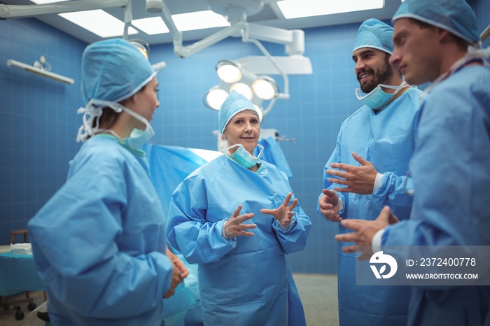 Team of surgeons having discussion in operation theater