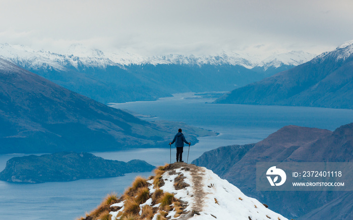 Hiker on top of the viewing spot of Roys Peak, Wanaka, New Zealand