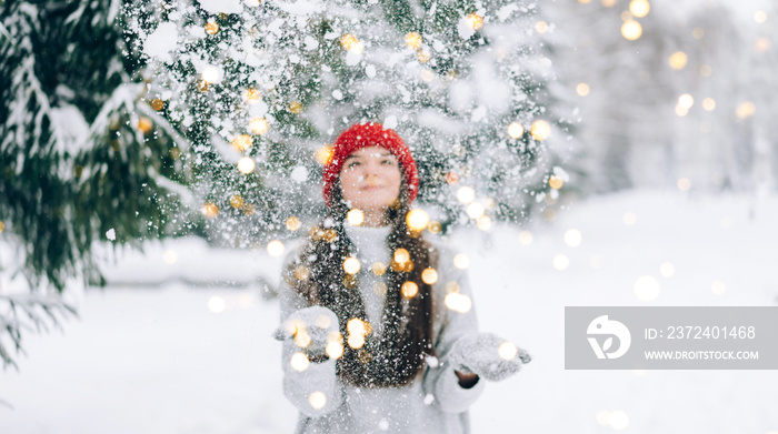 The girl in the red hat threw the snow up