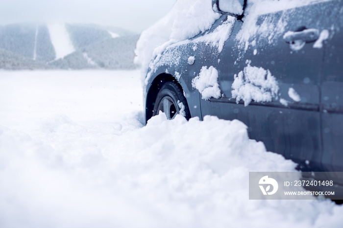 Snow covered car on a winter day.Frozen car covered snow at winter day,