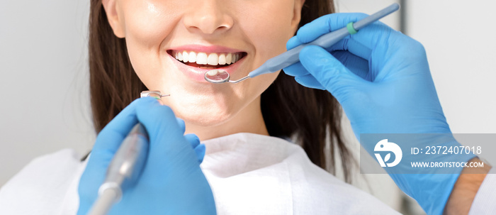 Cropped photo of woman mouth under treatment at dental clinic