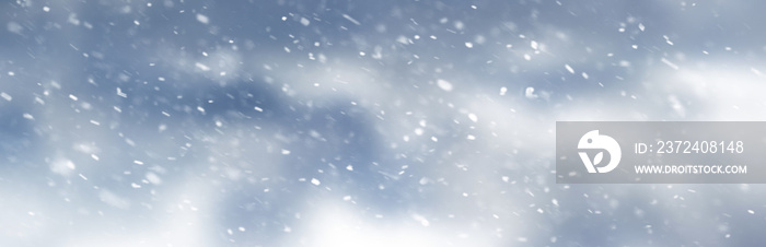 Abstract winter background with snowflakes on a blurred background
