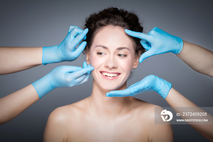 Smiling woman having skin checkup before plastic surgery.
