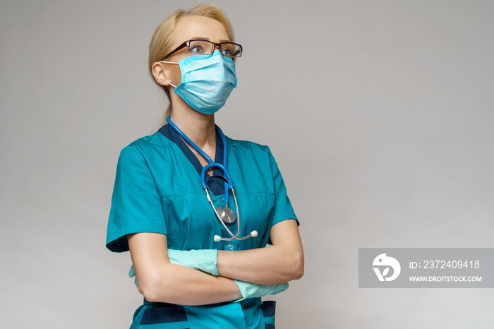 medical doctor nurse woman with stethoscope wearing protective mask and rubber or latex gloves