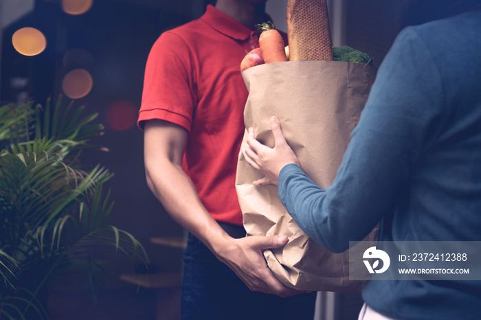 Delivery man send bag of vegetables and food to customers