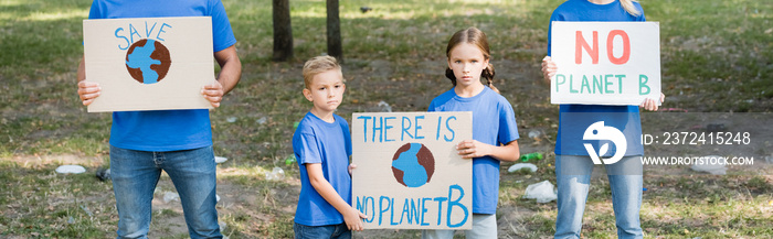 family of activists holding placards with globe and there is no planet b inscription, ecology concep