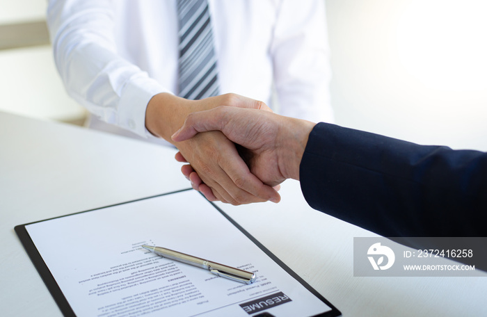 Business people shake hands to congratulate new employees in interviews after meeting in office, job