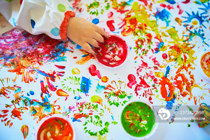 Hand of little girls painting with fingers