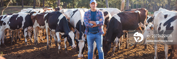 The male farmer is satisfied with his cows and his work.