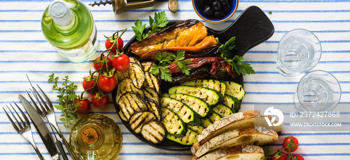 banner of grilled vegetables on the table with white wine, fresh bread and aromatic herbs. summer me