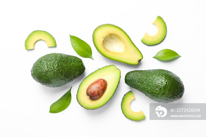 Flat lay composition with ripe avocados and leaves on white background, top view