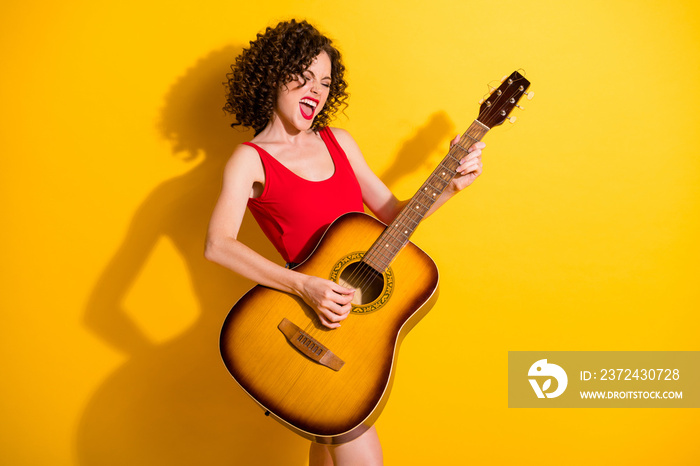 Portrait photo of funky girl with curly hair singing loudly holding keeping playing performing music