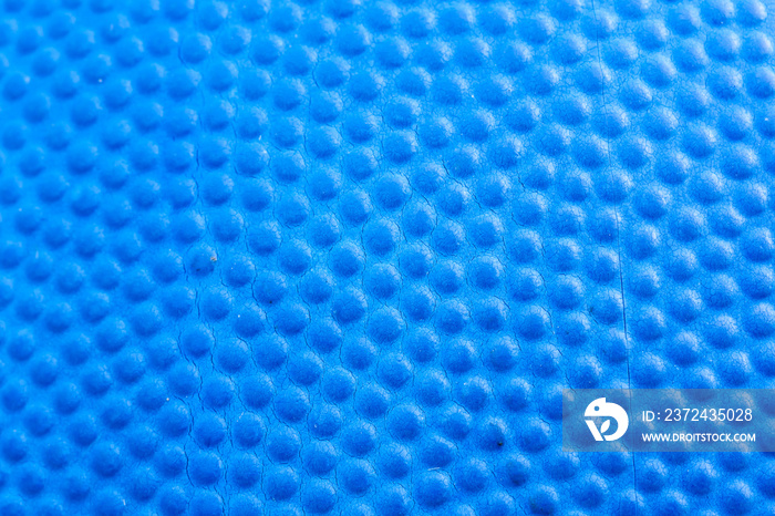 A blue background of basketball texture, macro close-up.