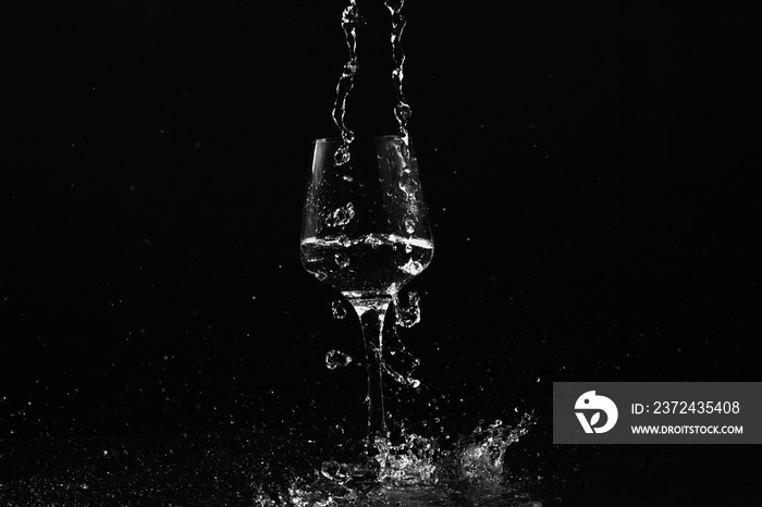 water pouring down into wine glass, abstract art black and white tone