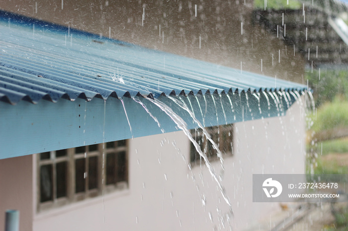 Falling rain from the roof on house.