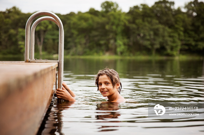 Portrait of boy swimming in lake