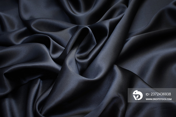 Silk fabric, satin. Black colour. Texture, background, pattern.