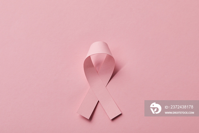 top view of breast cancer ribbon on pink background