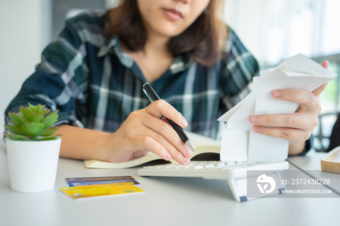 Confused portrait young woman holding credit cards having problem online payment with credit card ma