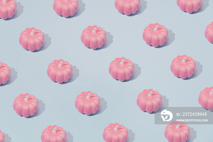 Autumn pattern in pastel pink and blue. Halloween pumpkins minimal background.