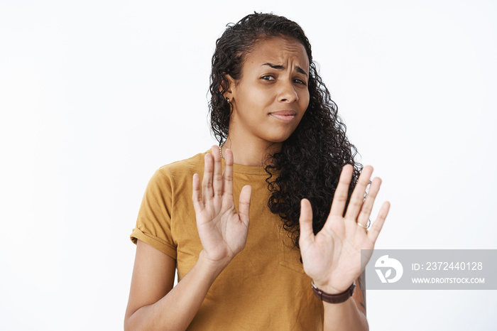 Close-up shot of disappointed and uninterested african-american female customer frowning from disgus