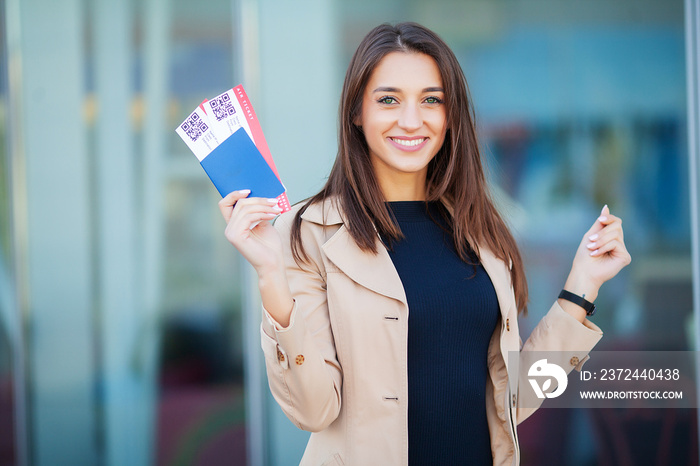 Travel. Woman holding two air ticket in abroad passport near airport