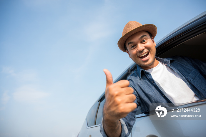 Asian men wear hats The blue shirt is driving and thumbs up This picture is about Travel by car, car