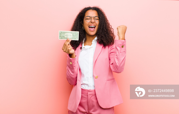 young black pretty woman with dollar banknotes against pink wall background