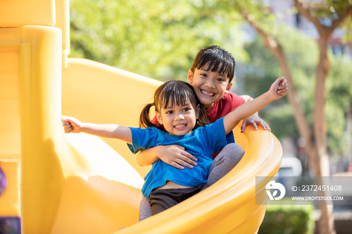 Asian Siblings playing at the playground and smiled and laughed happy