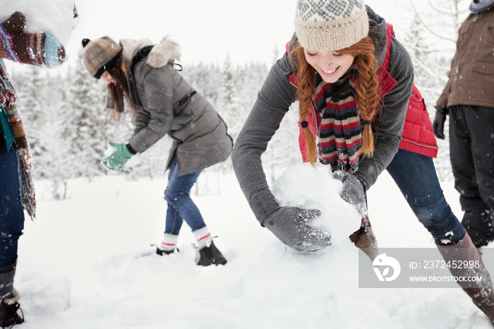 adults building snowmen