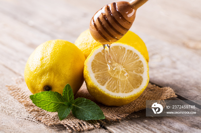 Closeup of lemon and honey on wooden table