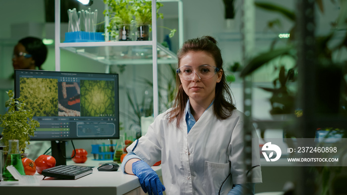 Portrait of chemist woman in white coat working in pharmaceutical laboratory. Biologist scientific a