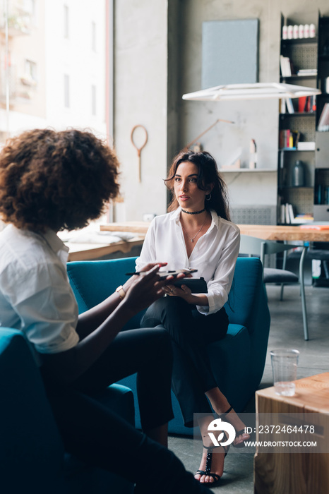 Two young girls having business meeting