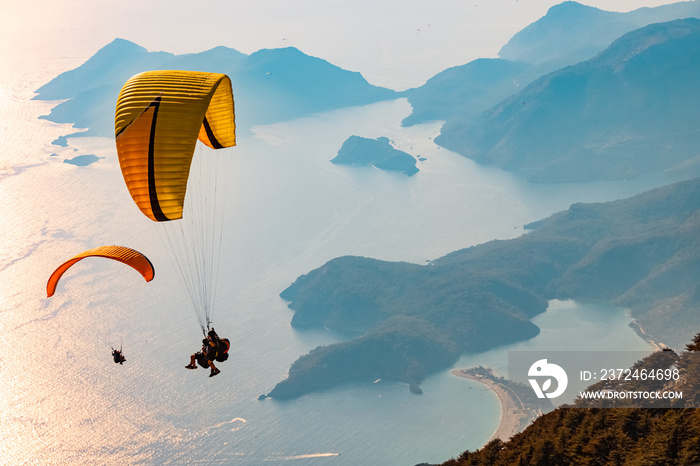 Paraglider tandem flying over the Oludeniz at sunset. Fethiye, Mugla.